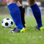 why do football players rip or cut their socks