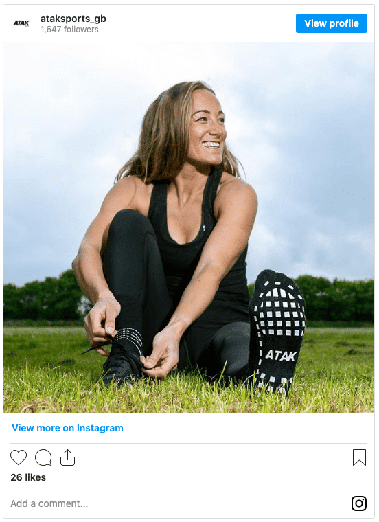 woman football players wearing grippy socks instagram post