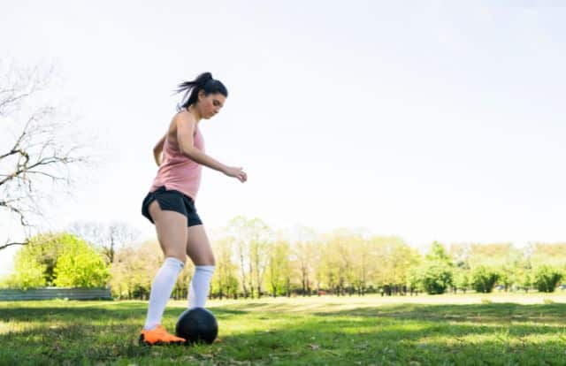 woman practising her football skills to get better