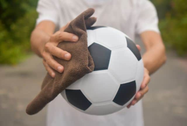 step 5 dry the ball. man dries the ball with a soft cloth