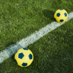 Top- view of two soccer balls on playground floor