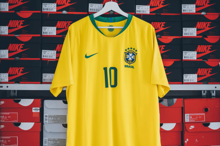 A Nike yellow football shirt hanged in a Nike store