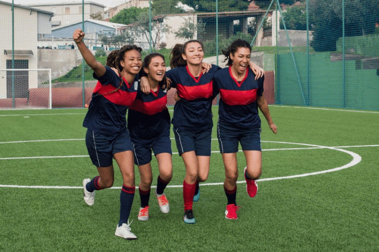 A group of female soccer players having fun after training