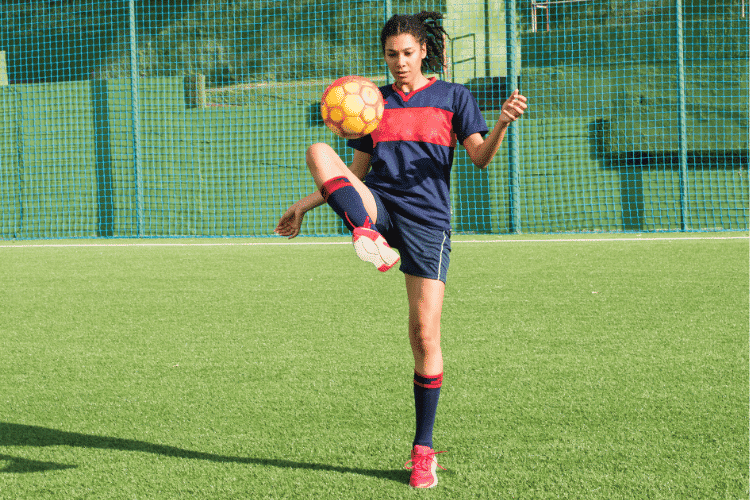 A young female player playing soccer