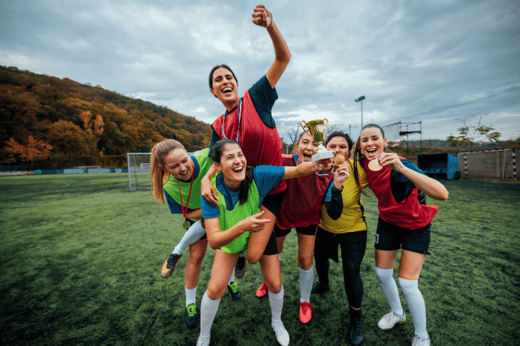 Ecstatic female football players celebrating their win