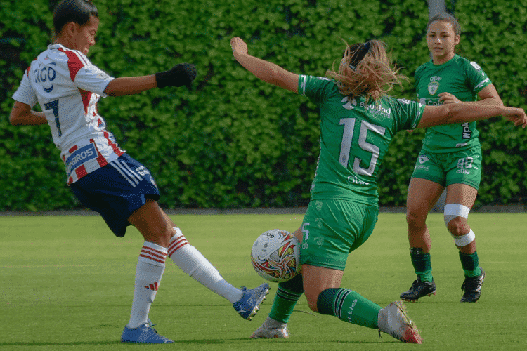Female soccer players playing at a soccer field
