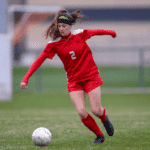 A female player playing soccer