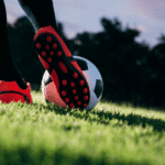 Close up of a soccer player kicking the ball