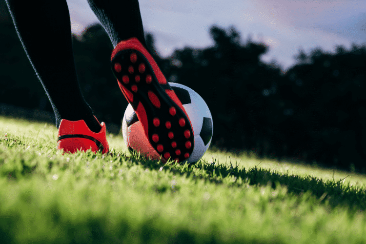Close-up of a soccer player kicking the ball