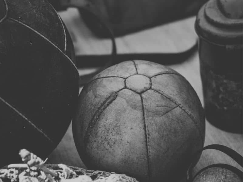 soccer history - old leather soccer ball in a changing room